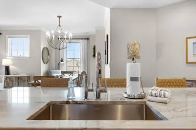 a kitchen with a sink and a living room at Casa Del Oro Penthouse at Barrett Square - Downtown Rosemary Beach Pool &Hot Tub Access in Rosemary Beach