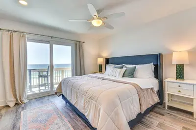 a bedroom with a bed and a large window at Steps to Sand Condo with Pool in Panama City Beach in Panama City Beach