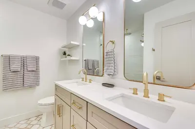 a white bathroom with a sink and a mirror at Steps to Sand Condo with Pool in Panama City Beach in Panama City Beach