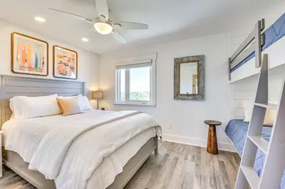 a bedroom with a bed and a ceiling fan at Steps to Sand Condo with Pool in Panama City Beach in Panama City Beach