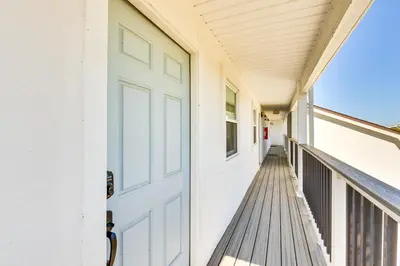 a porch with a white door on a house at Steps to Sand Condo with Pool in Panama City Beach in Panama City Beach