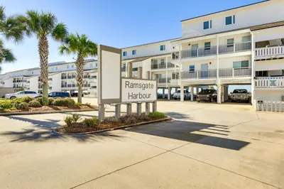 a sign in front of a apartment building at Steps to Sand Condo with Pool in Panama City Beach in Panama City Beach