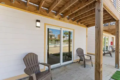 two chairs on the porch of a house at Ocean Breeze 5A in Panama City Beach