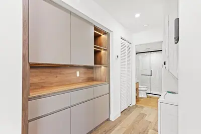 a kitchen with white cabinets and a toilet at Ocean Breeze 5A in Panama City Beach