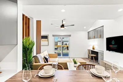 a dining room and living room with a table and chairs at Ocean Breeze 5D in Panama City Beach