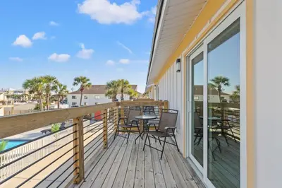 a patio with a table and chairs on a deck at Ocean Breeze 5D in Panama City Beach