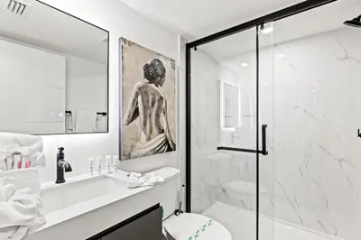 a bathroom with a shower and a toilet and a sink at Ocean Breeze 5D in Panama City Beach