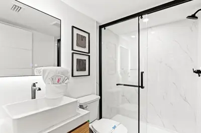 a white bathroom with a shower and a toilet at Ocean Breeze 5B in Panama City Beach