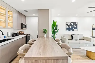 a kitchen and living room with a wooden table at Ocean Breeze 5B in Panama City Beach