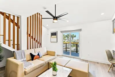 a living room with a couch and a ceiling fan at Ocean Breeze 5C in Panama City Beach