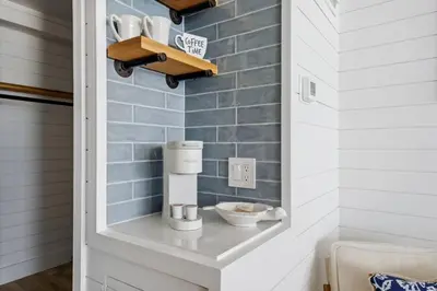 a kitchen with a coffee maker on a shelf at Beach Front Ocean View Condo - Top of the Gulf 521 in Panama City Beach