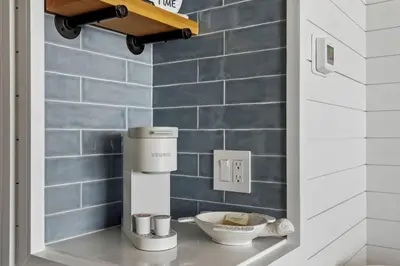 a coffee machine on a shelf in a bathroom at Beach Front Ocean View Condo - Top of the Gulf 521 in Panama City Beach
