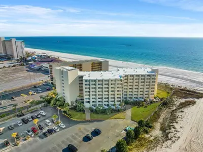 an aerial view of a building next to the beach at Beach Front Ocean View Condo - Top of the Gulf 521 in Panama City Beach