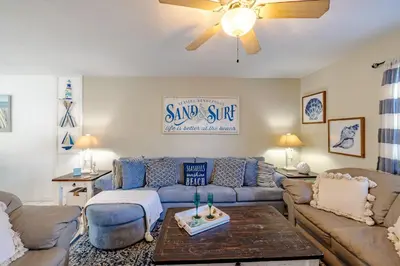 a living room with a couch and a table at Captain's Quarters at Gulf Highlands Beach Resort in Panama City Beach