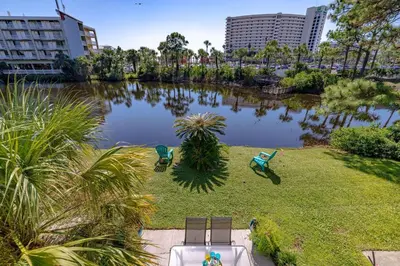 an aerial view of a park with chairs and a lake at Captain's Quarters at Gulf Highlands Beach Resort in Panama City Beach