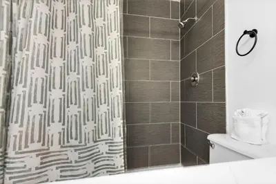 a bathroom with a shower curtain and a toilet at Top of the Gulf 507 Beach Front Resort Ocean View in Panama City Beach