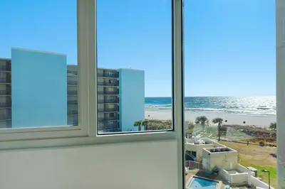 a view of the beach from a hotel room window at Top of the Gulf 507 Beach Front Resort Ocean View in Panama City Beach