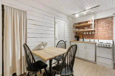 a dining room with a wooden table and chairs at Cowboy Cottage by Beach Haven Vacation Rentals in Panama City Beach