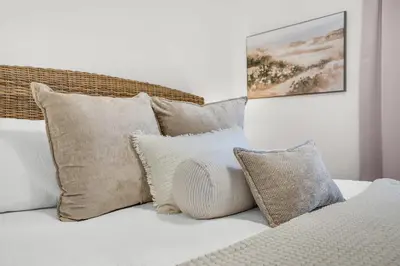 a bunch of pillows sitting on top of a bed at Seagrove Siesta at Beachwood Villages - Walk to Beach Outdoor Pools & More in Santa Rosa Beach