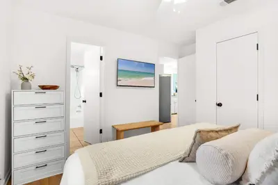 a white bedroom with a bed and a dresser at Seagrove Siesta at Beachwood Villages - Walk to Beach Outdoor Pools & More in Santa Rosa Beach