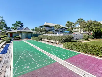 a basketball court in a yard next to a house at Seagrove Siesta at Beachwood Villages - Walk to Beach Outdoor Pools & More in Santa Rosa Beach