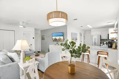 a living room with a vase on a wooden table at Seagrove Siesta at Beachwood Villages - Walk to Beach Outdoor Pools & More in Santa Rosa Beach