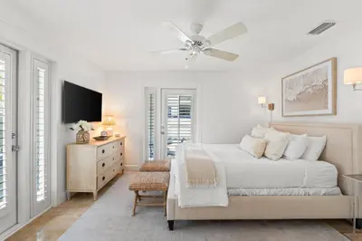 a white bedroom with a bed and a ceiling fan at 30A Sunset Beach House - Villa Infinity by Panhandle Getaways in Seacrest