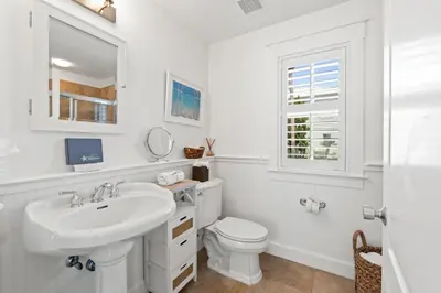 a white bathroom with a sink and a toilet at 30A Sunset Beach House - Villa Infinity by Panhandle Getaways in Seacrest