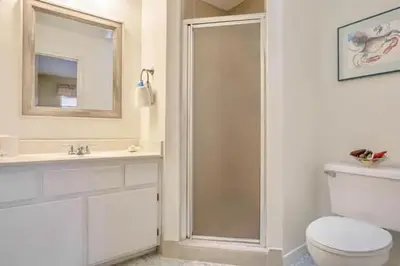 a bathroom with a shower and a toilet and a sink at Dream Come True in PCB in Panama City Beach