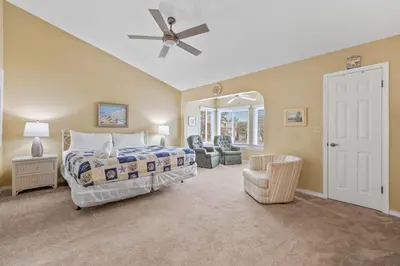 a bedroom with a bed and a ceiling fan at Dream Come True in PCB in Panama City Beach