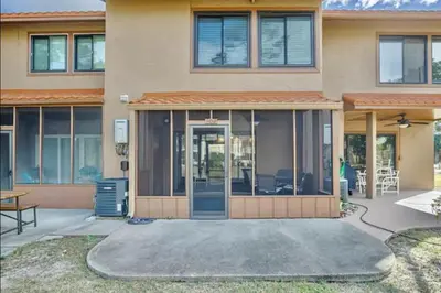 a house with a large glass door in front of it at Dream Come True in PCB in Panama City Beach