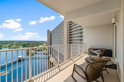 a balcony with chairs and a view of the water at Laketown Wharf #1231 in Panama City Beach