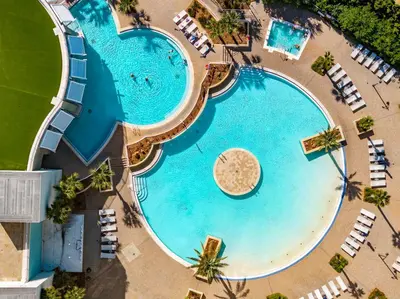 an overhead view of a swimming pool with chaise lounges and a beach at Laketown Wharf #1231 in Panama City Beach