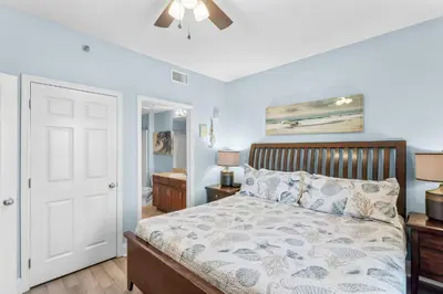 a bedroom with a bed and a ceiling fan at Laketown Wharf #0613 in Panama City Beach