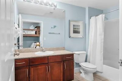 a bathroom with a sink and a toilet and a shower at Laketown Wharf #0613 in Panama City Beach