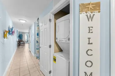 a hallway with a washer and dryer in a house at Laketown Wharf #0613 in Panama City Beach
