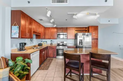a kitchen with wooden cabinets and a counter top at Laketown Wharf #0613 in Panama City Beach
