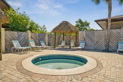a swimming pool with chairs and a gazebo at Portside Resort AA1 by InJoy Vacations in Panama City Beach