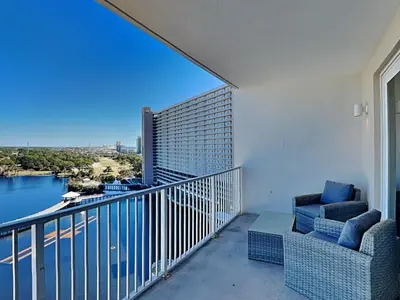 a balcony with two chairs and a view of the water at Laketown Wharf #1137 in Panama City Beach