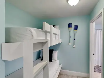 a white bunk bed in a room with a blue wall at Laketown Wharf #1137 in Panama City Beach