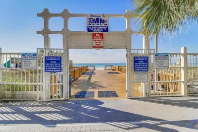 a gate at the beach with signs on it at The Summit 312 in Panama City Beach
