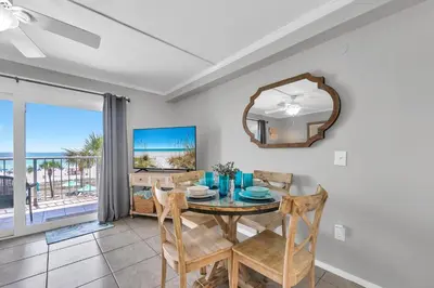 a dining room with a table and a mirror at The Summit 312 in Panama City Beach