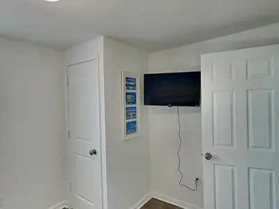a room with a white door and a television at Salt & Sea A in Panama City Beach