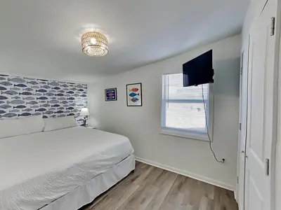 a bedroom with a bed and a flat screen tv at Salt & Sea A in Panama City Beach