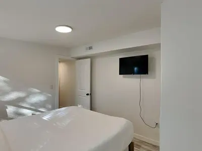 a bedroom with a bed and a tv on the wall at Salt & Sea B in Panama City Beach