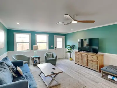 a living room with a couch and a flat screen tv at Salt & Sea B in Panama City Beach