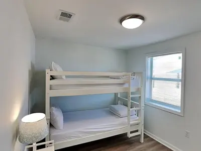 a bunk bed in a room with a window at Salt & Sea C in Panama City Beach