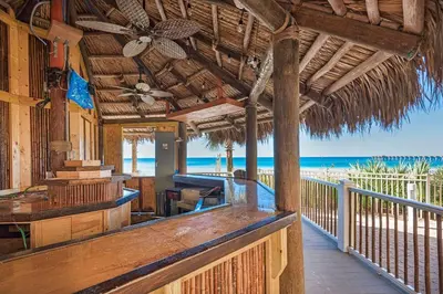 a porch of a resort with the beach in the background at Calypso 3-2007 by Emerald Coast Retreats in Panama City Beach