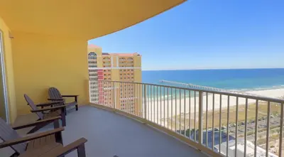 a balcony with chairs and a view of the ocean at Calypso 3-2007 by Emerald Coast Retreats in Panama City Beach