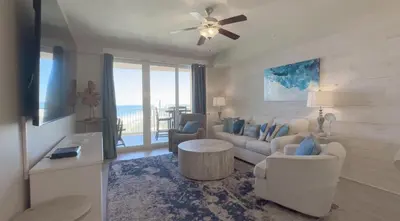 a living room with a couch and a table at Calypso 3-2007 by Emerald Coast Retreats in Panama City Beach